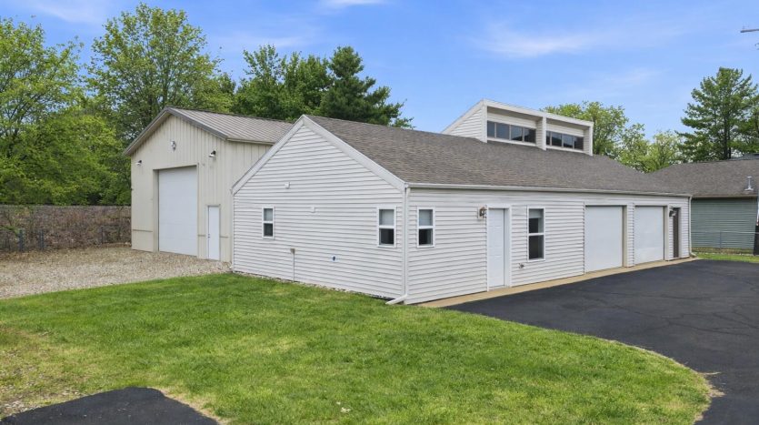 lake house with garage and outbuildings